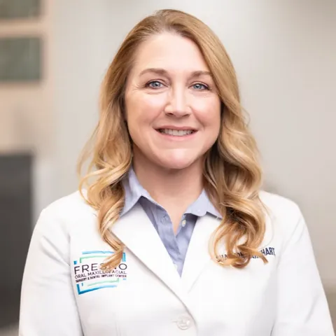Portrait of Dr. Shannon Barnhart, DDS, in a white coat